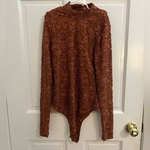 Women’s Iris bodysuit. Burnt orange and see through. Size small.